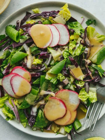 Lime tahini dressing on a crisp, fresh salad.