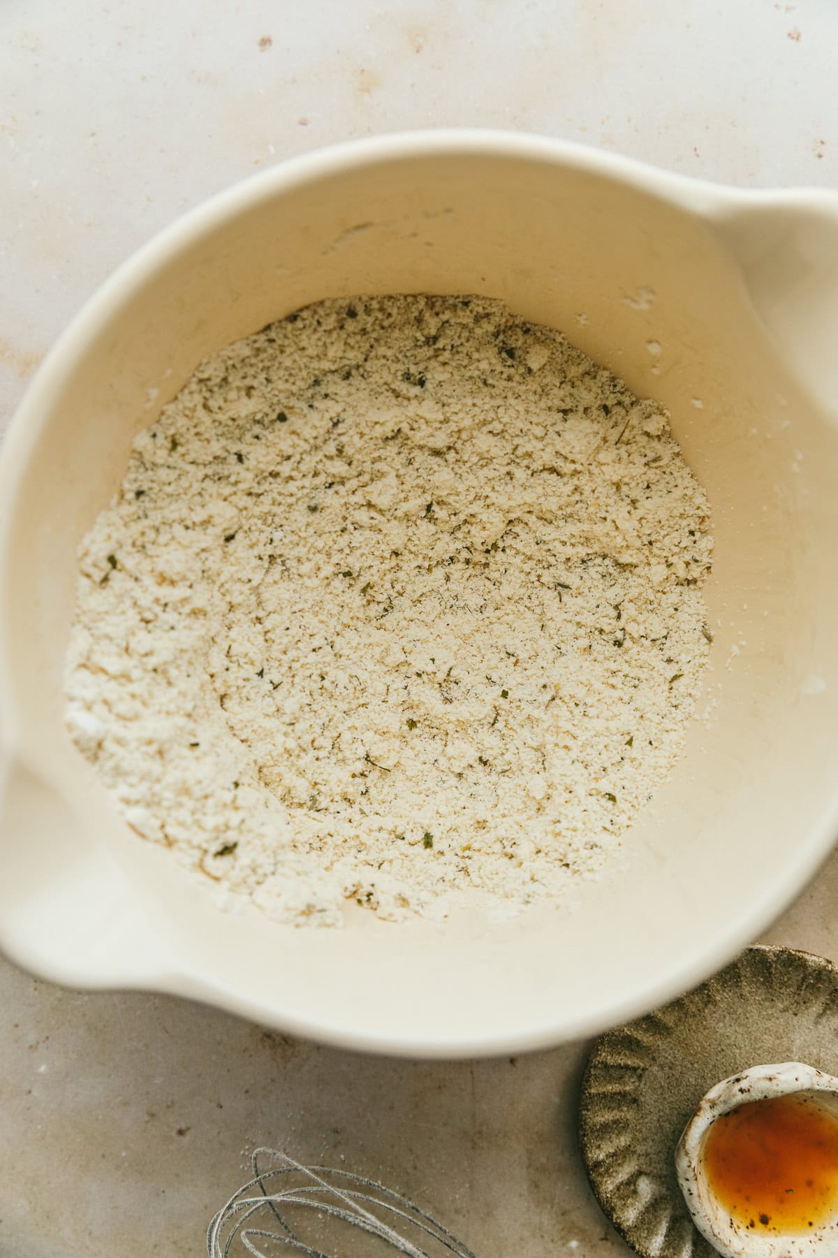 Dry ingredients for grain-free pizza crust in a mixing bowl.