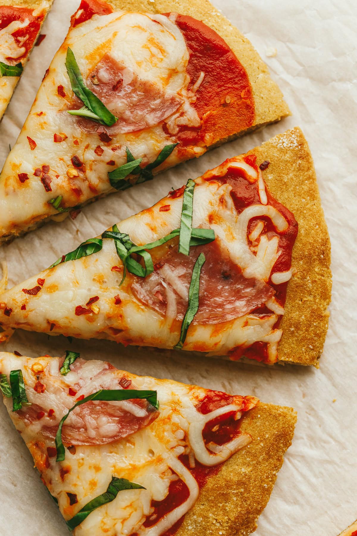 Three slices of low-carb and grain-free pizza with toppings.