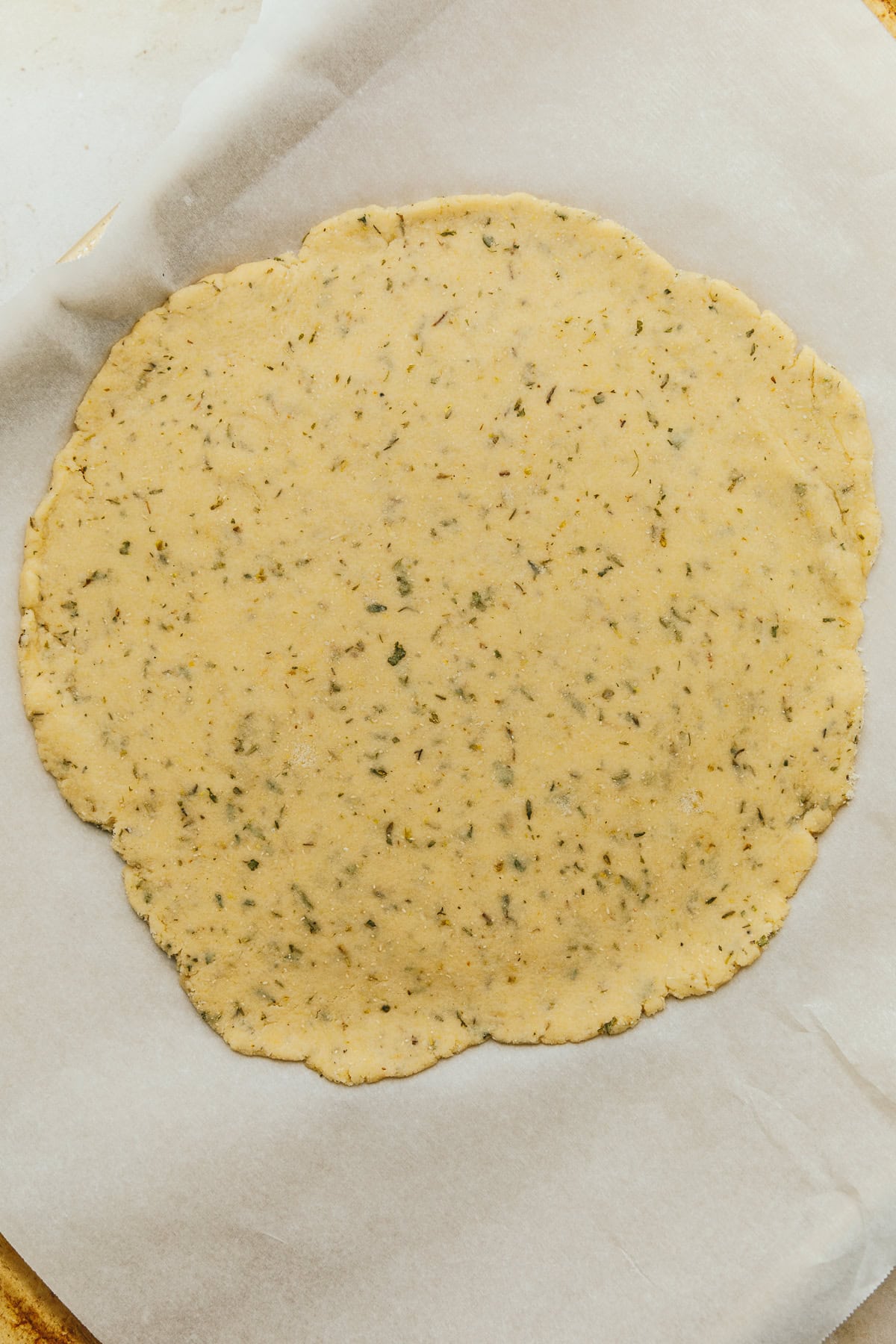 Rolled out grain-free pizza dough before baking.