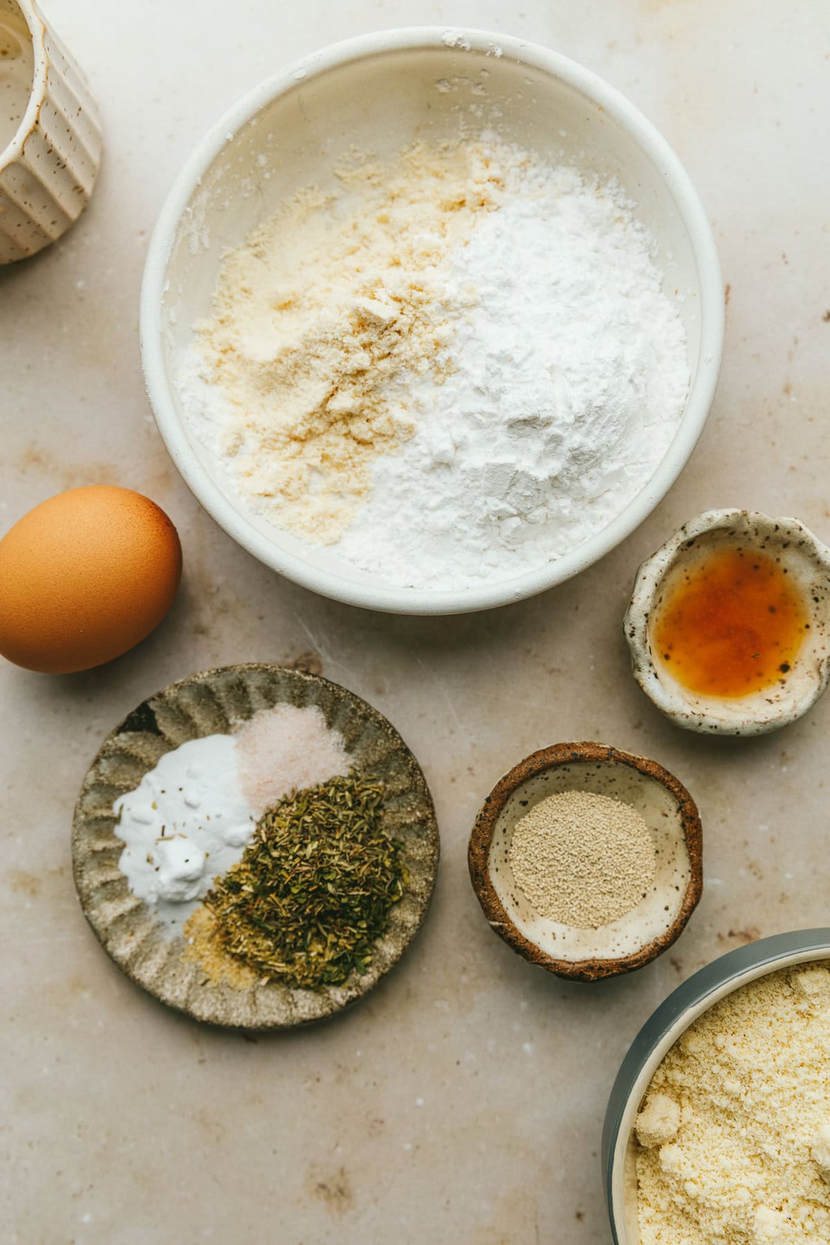 Ingredients for grain-free pizza crust on a marble countertop.