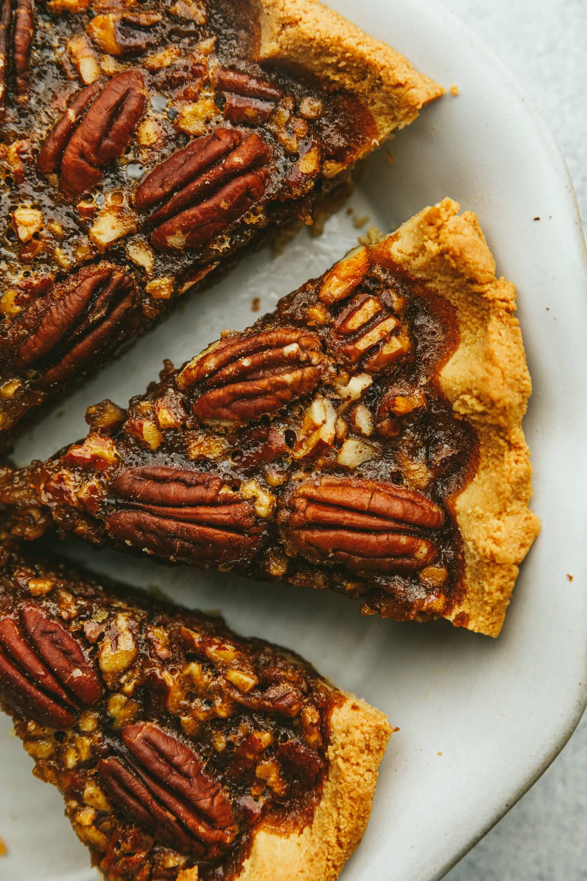 Slices of keto pecan pie in a pie dish.