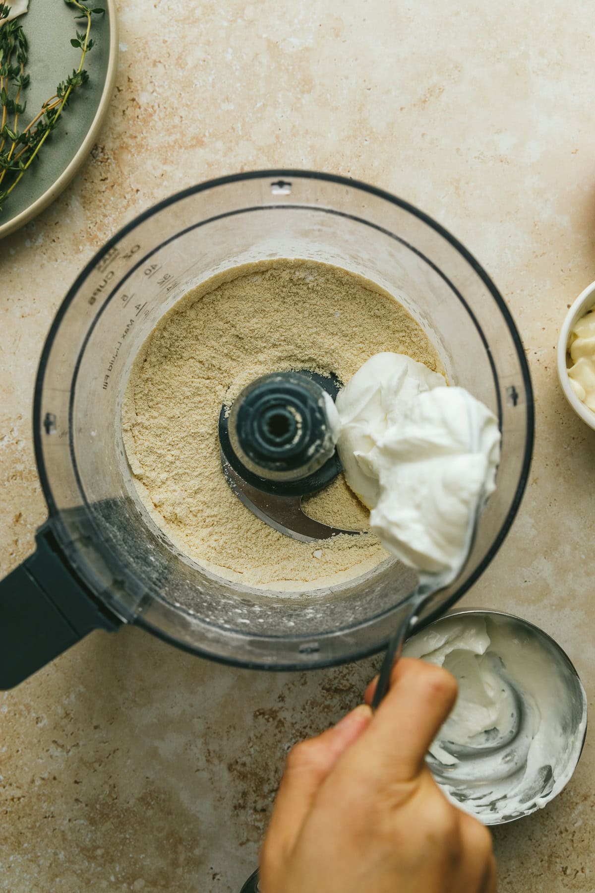 Spooning Greek yogurt into the dry ingredients for low-carb flatbread.