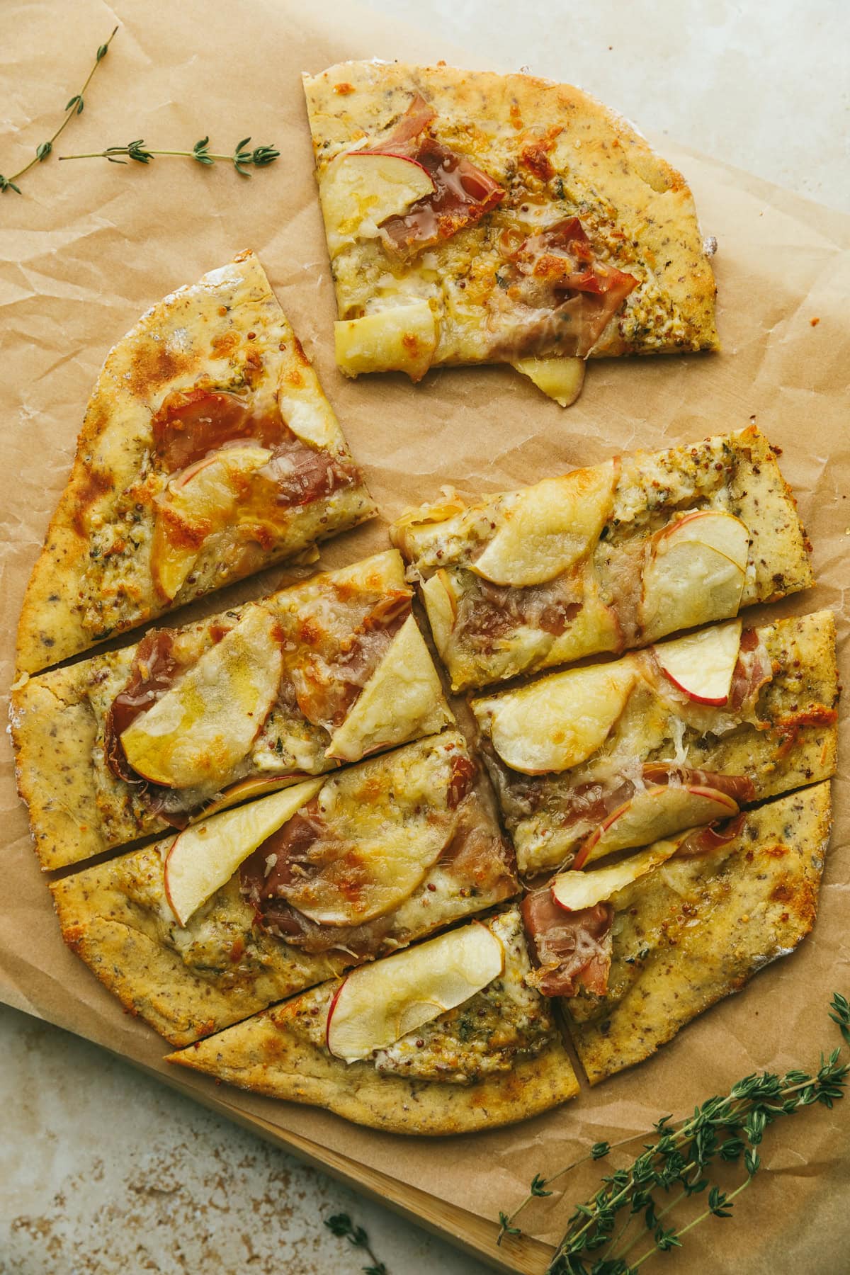 Low carb flatbread with prosciutto and apple slices.