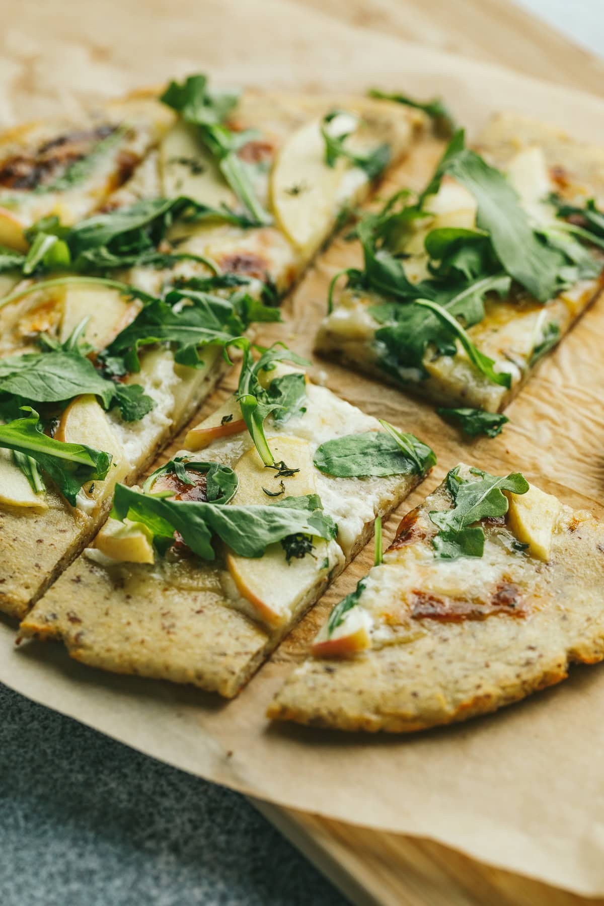 Slices of low-carb flatbread topped with fresh arugula.