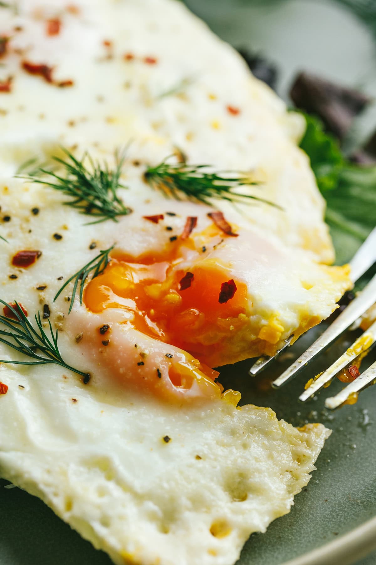 Closeup of the yolky center of a cream fried egg.