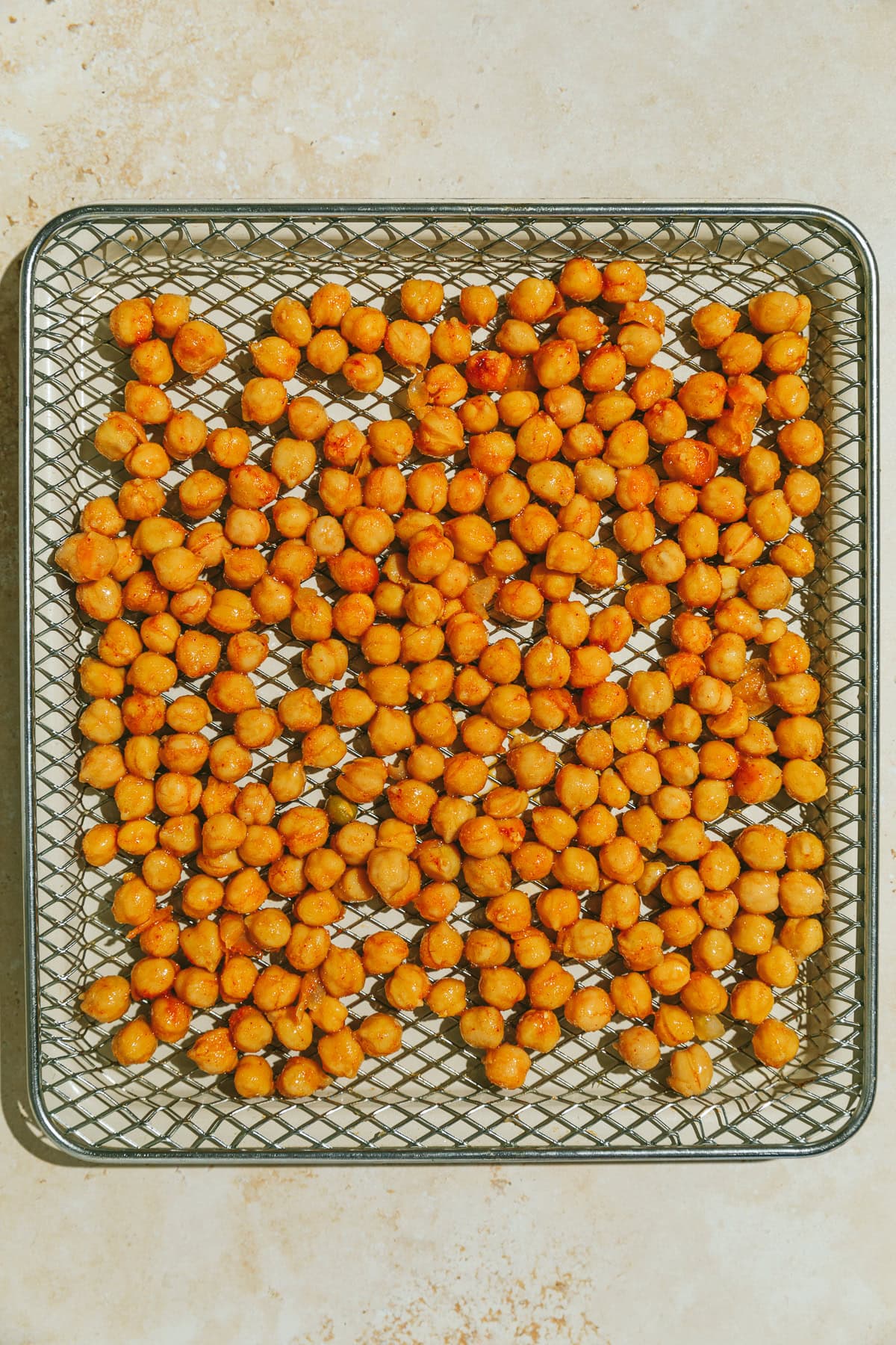 Chickpeas on an air fryer rack.