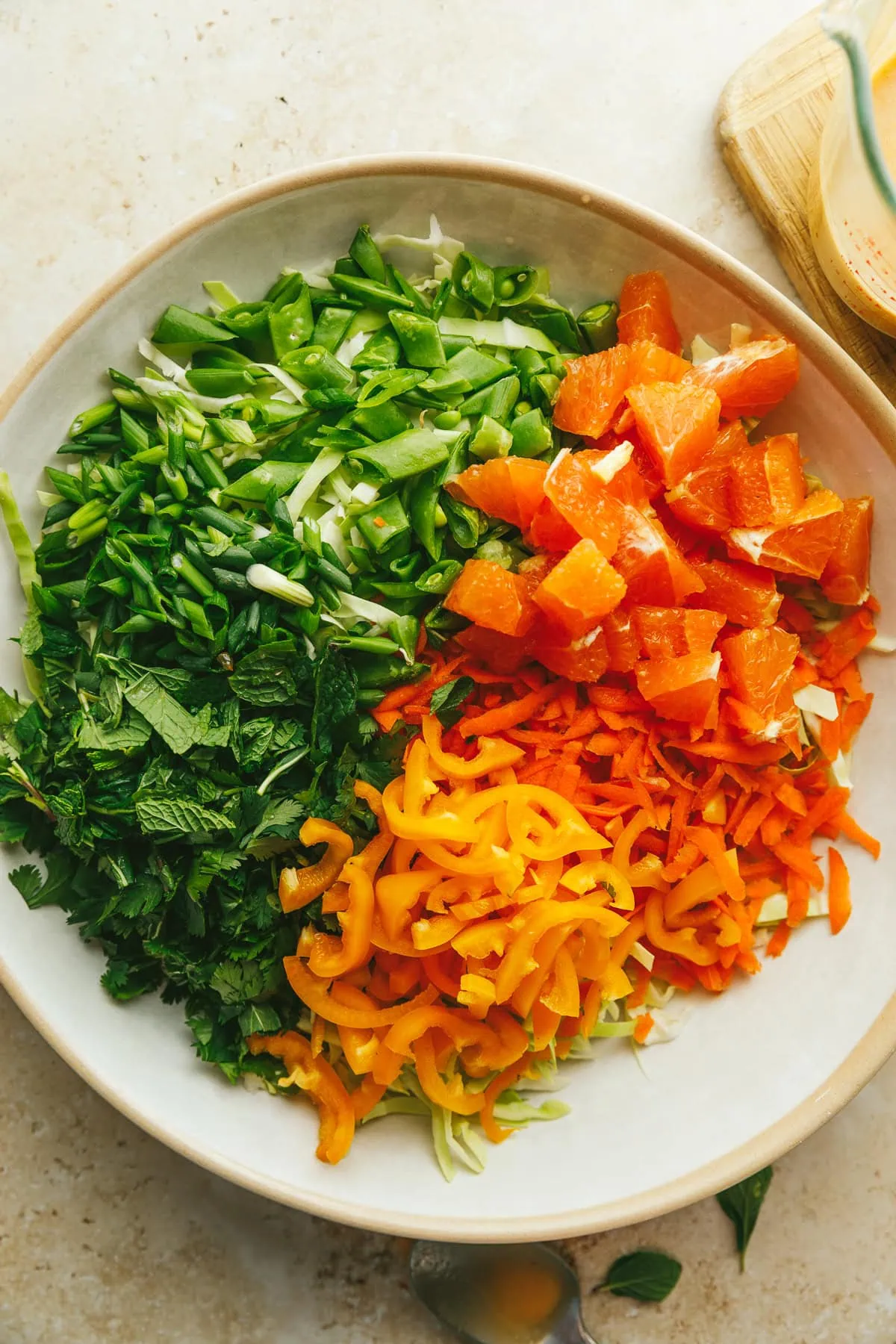 Ingredients for cabbage crunch salad in the salad bowl before tossing.