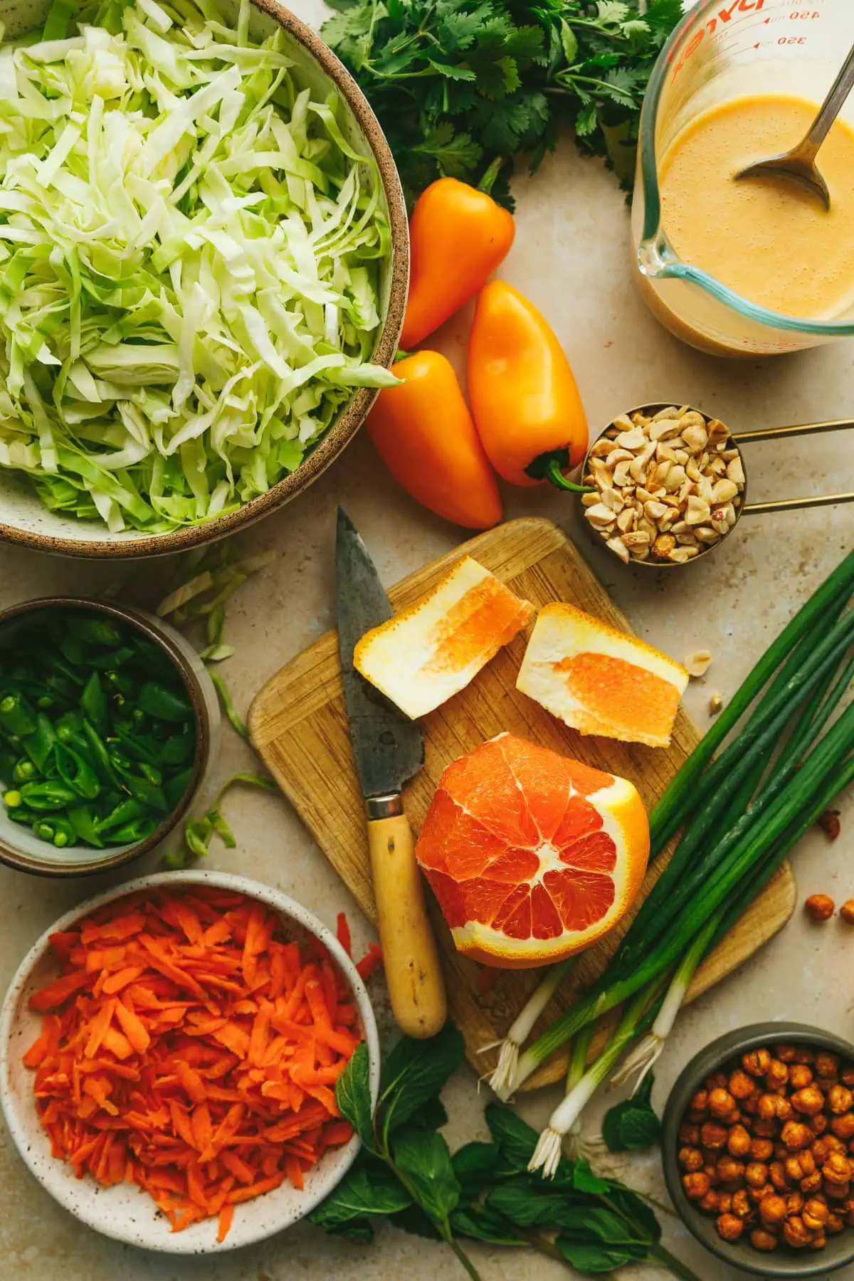 Ingredients for cabbage crunch salad spread out on a countertop.