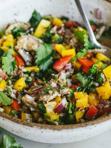 Sardine escabeche in a serving bowl with a fork.