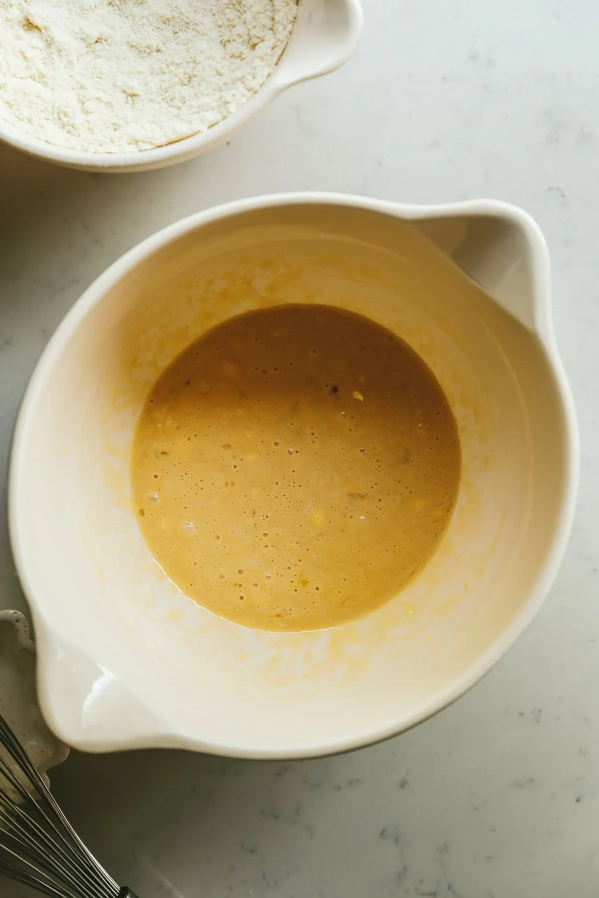 A bowl with wet ingredients and a bowl with dry ingredients for low-carb cinnamon rolls.