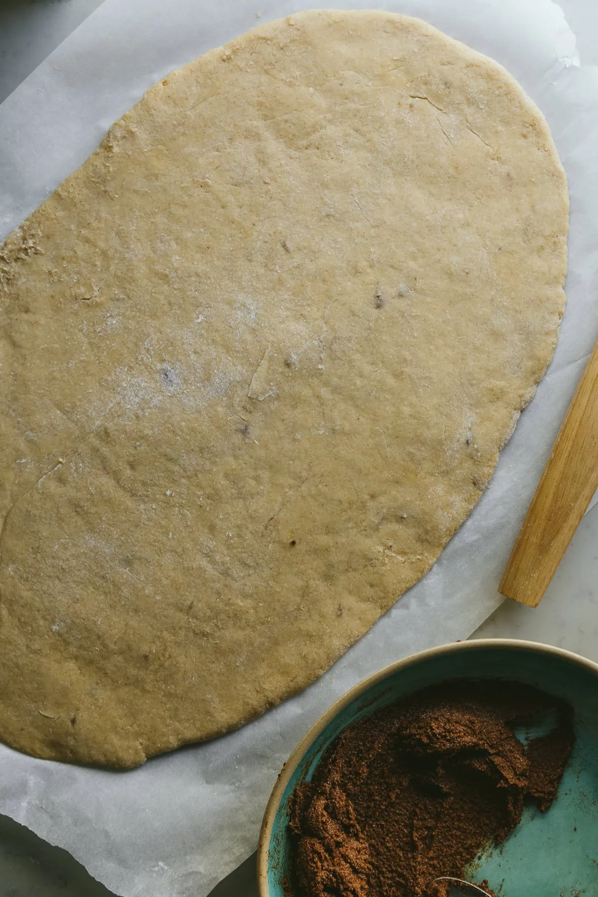 Low-carb cinnamon roll dough and the cinnamon mixture in a bowl next to it.