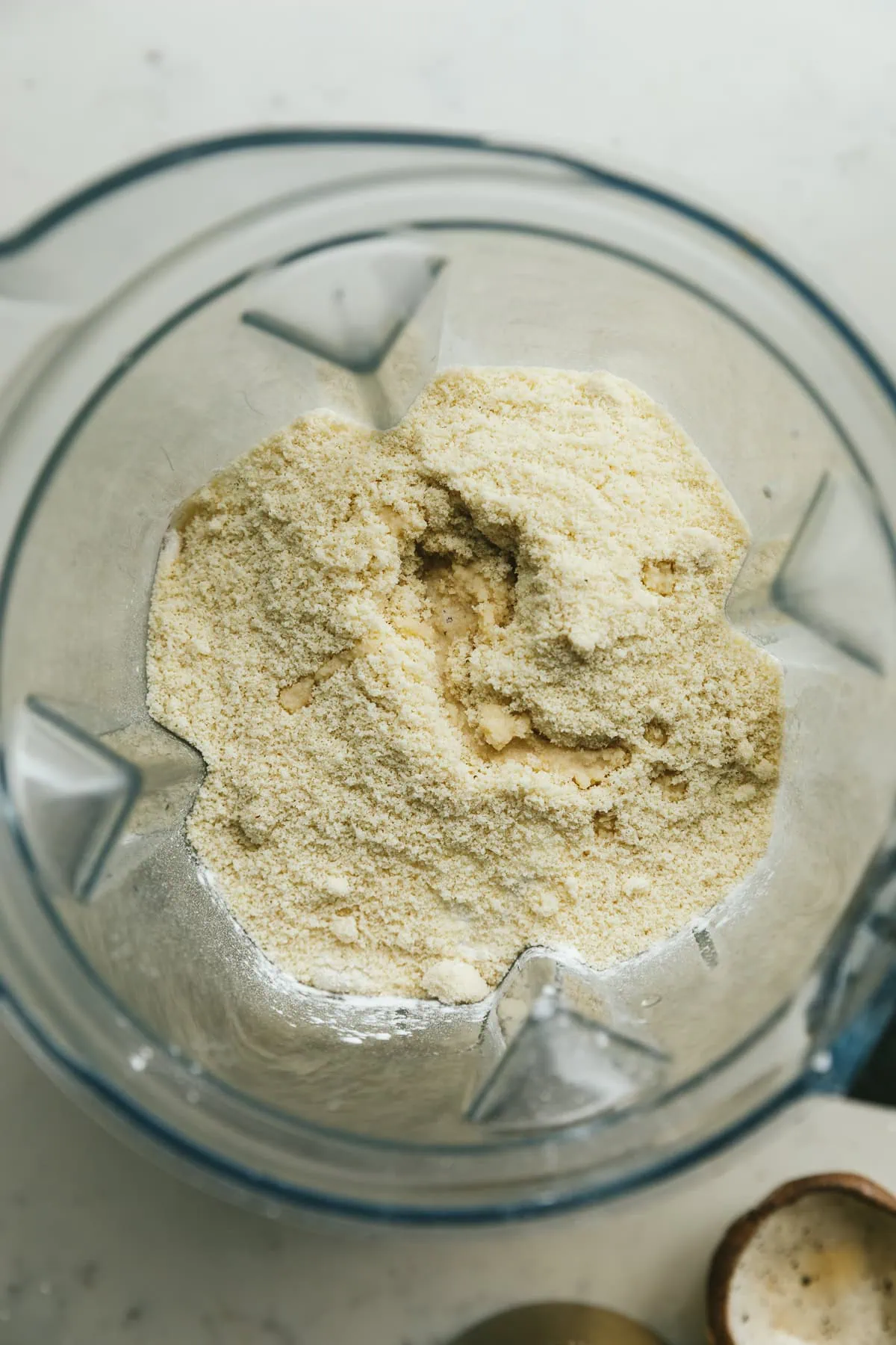 A blender holding ingredients for keto cottage cheese pancakes.