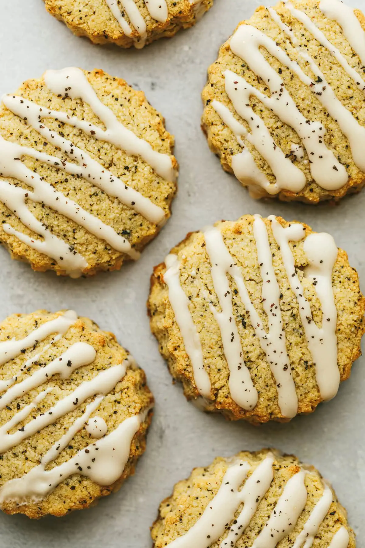 Overhead shot of glazed earl grey scones sprinkled with crushed tea leaves.
