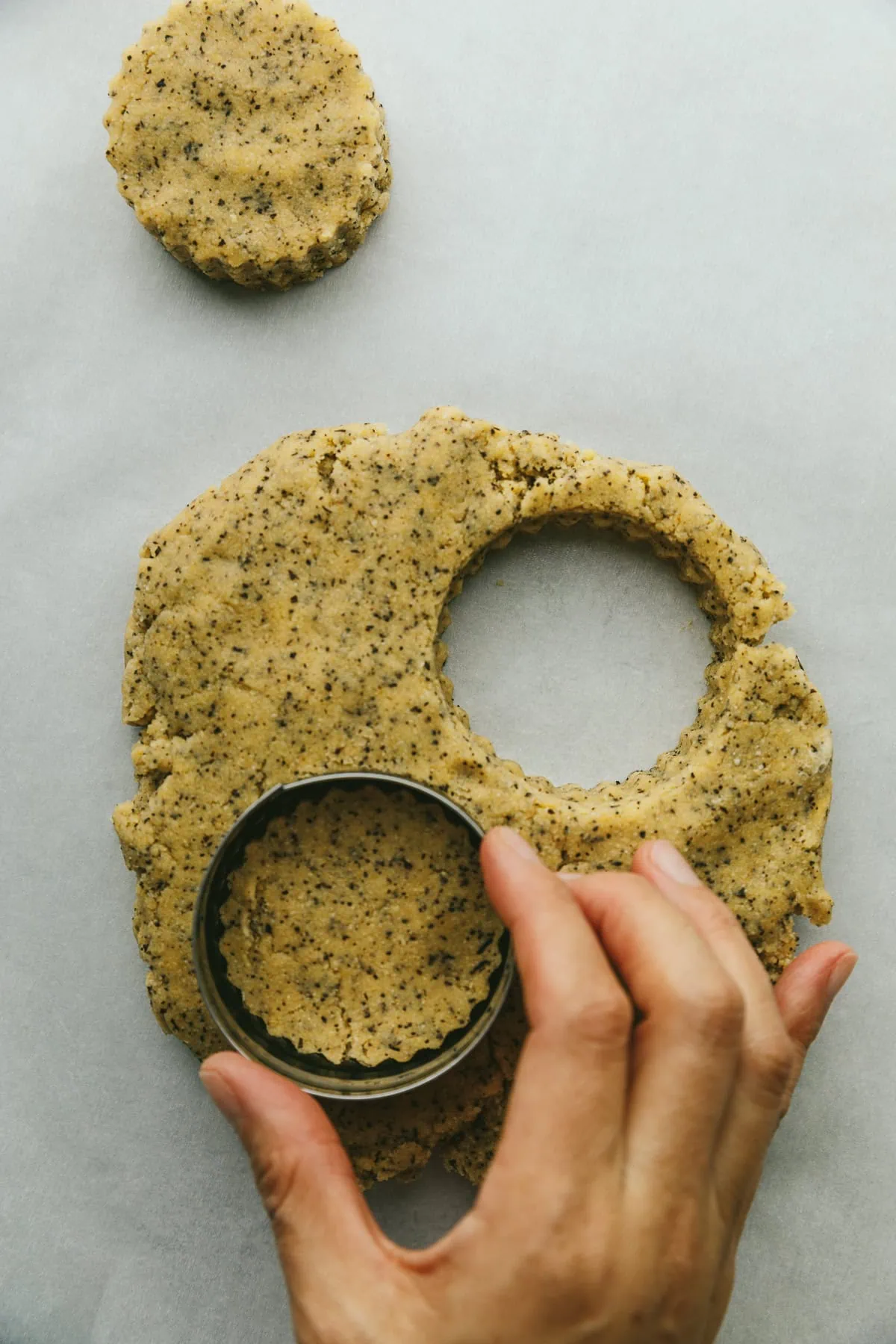 Cutting out earl grey scones with a cookie cutter.