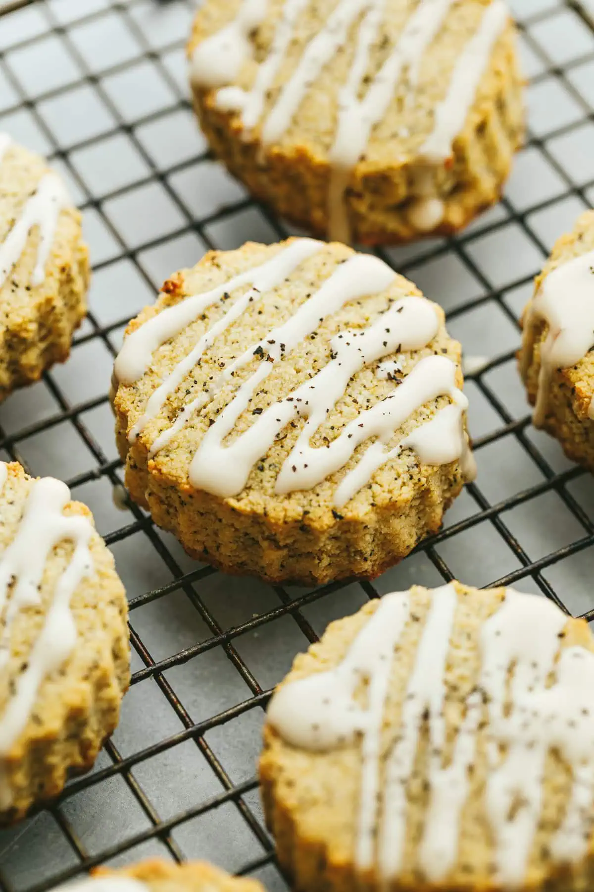 Glaze earl grey scones resting on a wire rack.