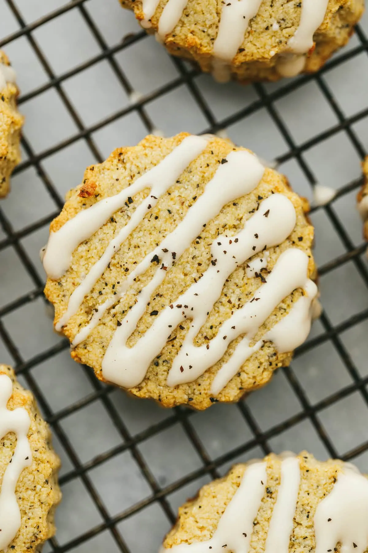 Closeup of the glaze on an earl grey scone on a cooling rack.