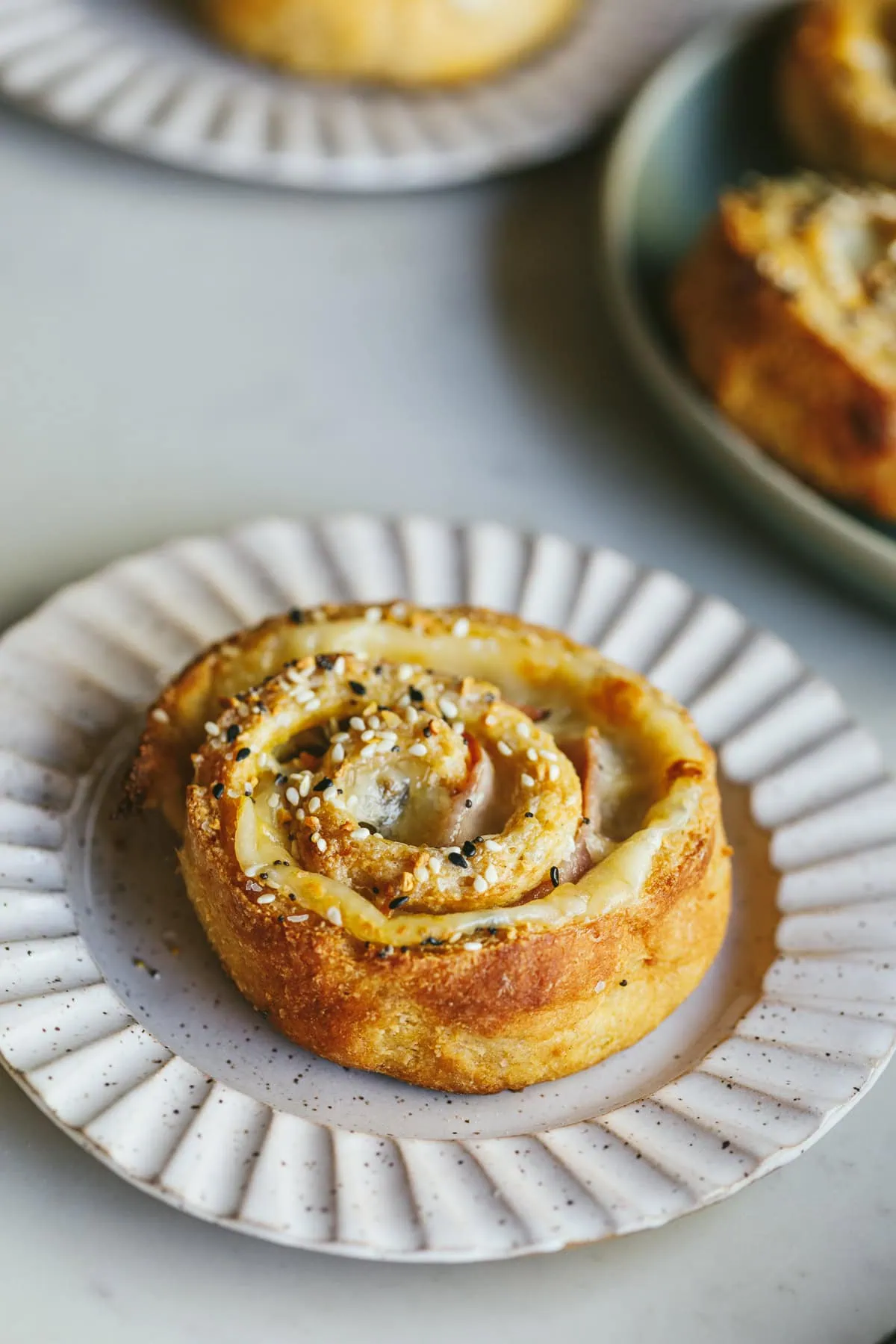 A keto pinwheel on a scalloped serving plate.