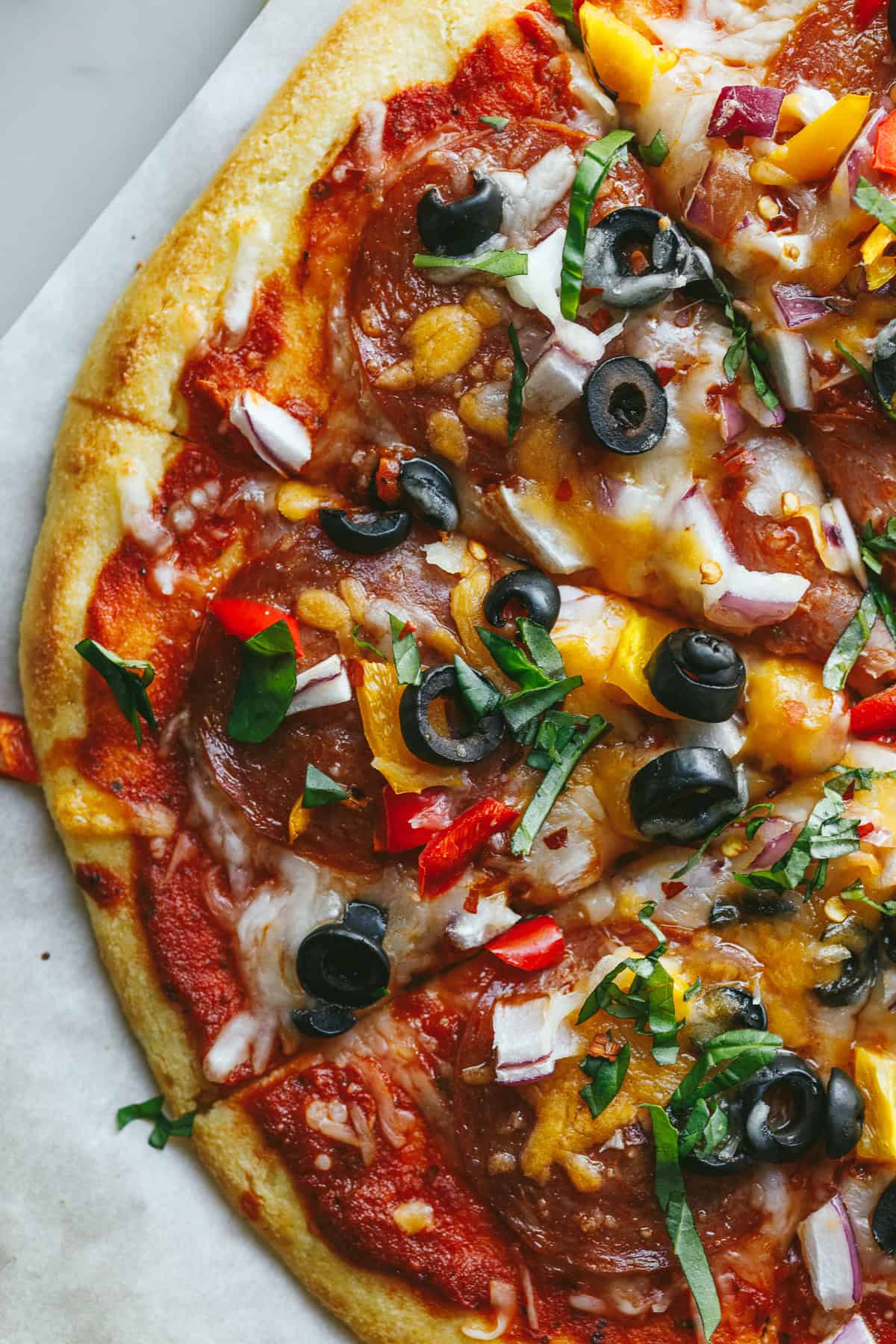 Closeup of a baked keto cottage cheese pizza with toppings.