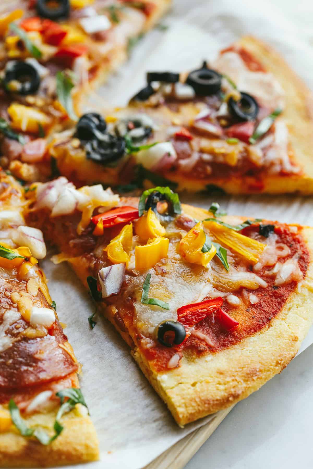 A closeup of a slice of keto cottage cheese pizza after baking.