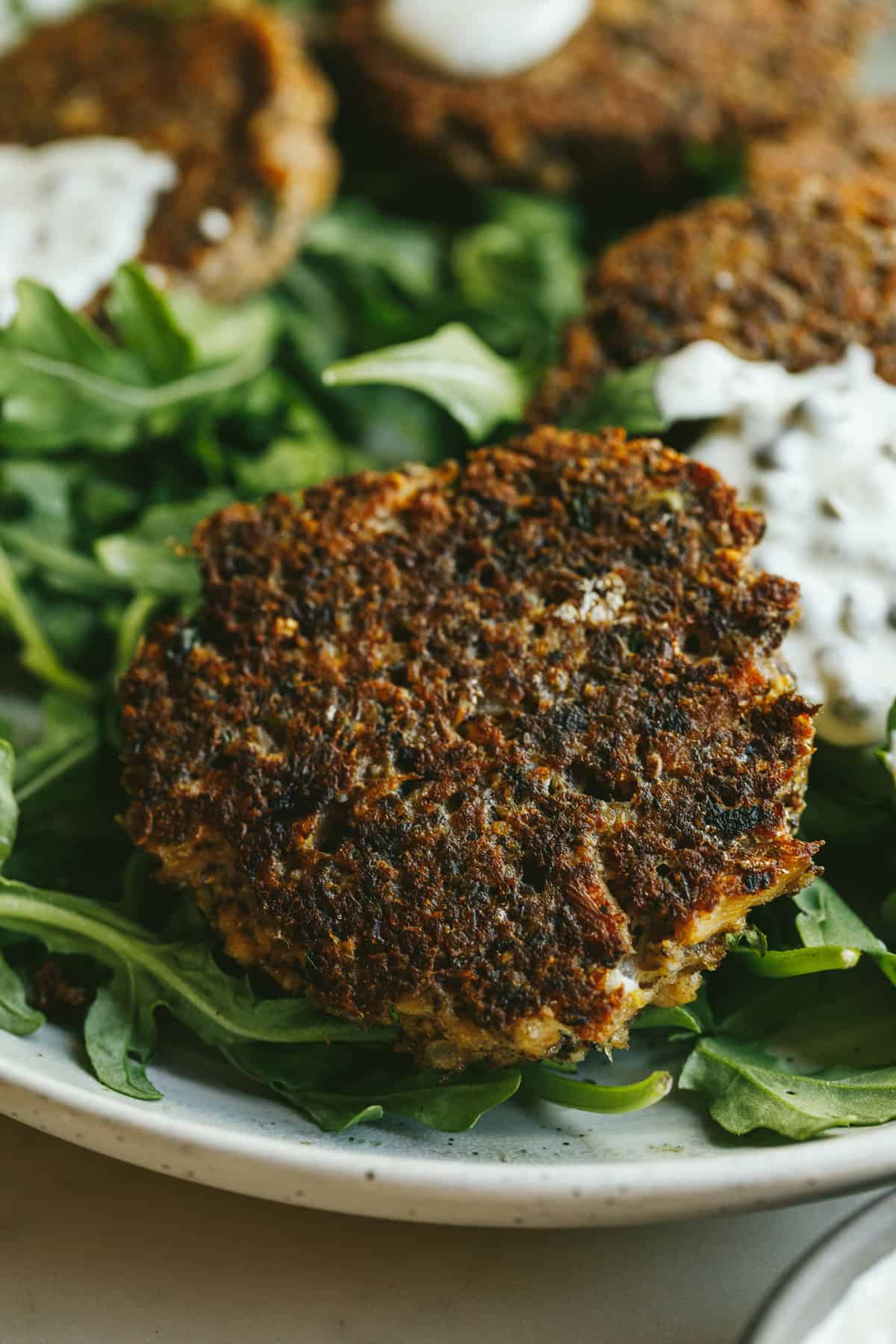 Crispy sardine cakes on arugula.