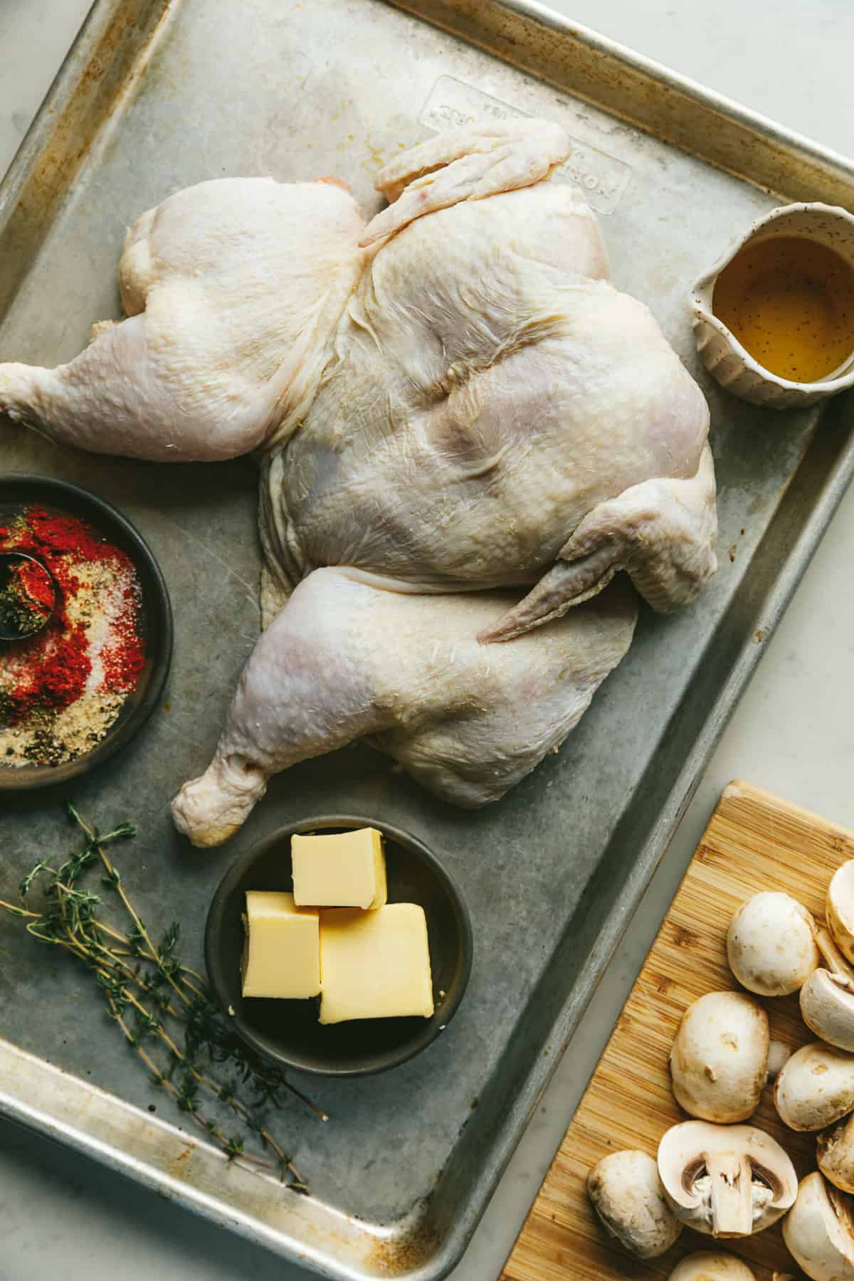 Ingredients for brown butter chicken on a baking sheet.