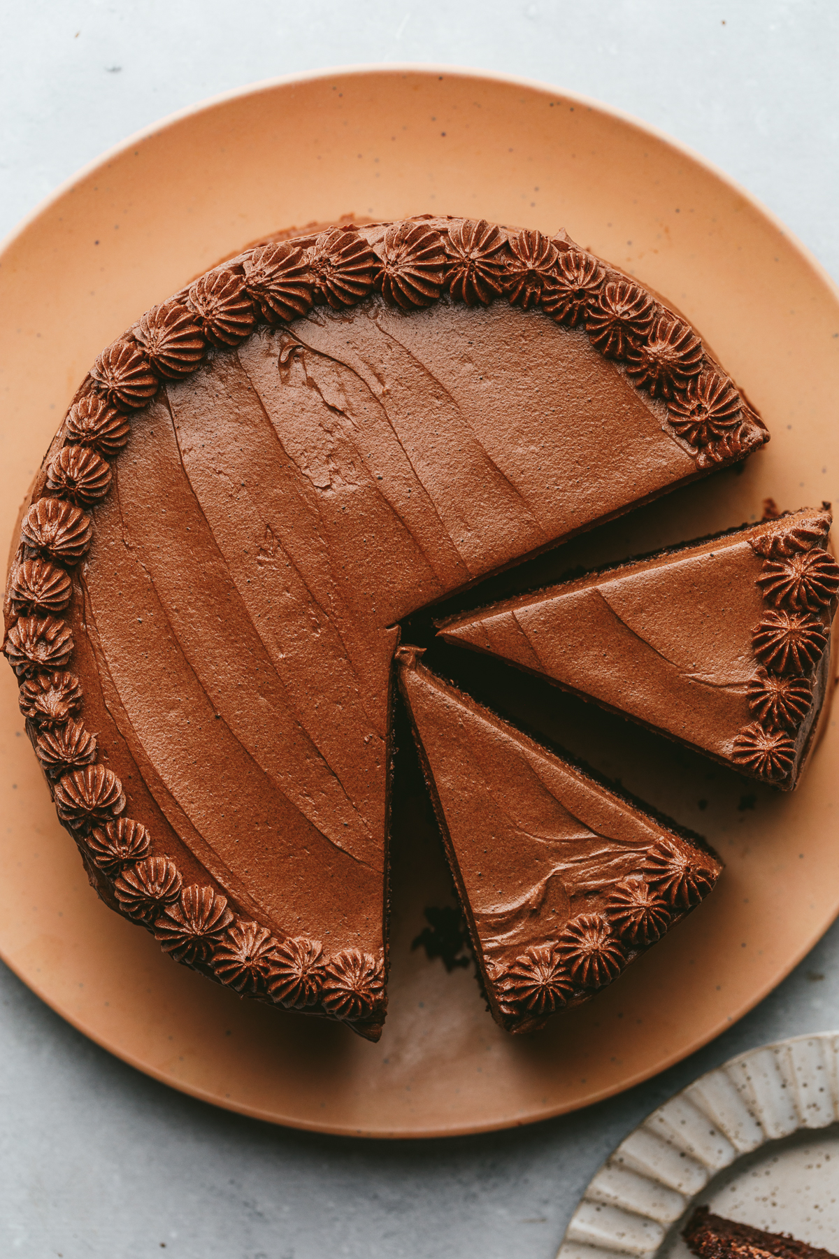 A keto chocolate cake with two slices cut out of it.